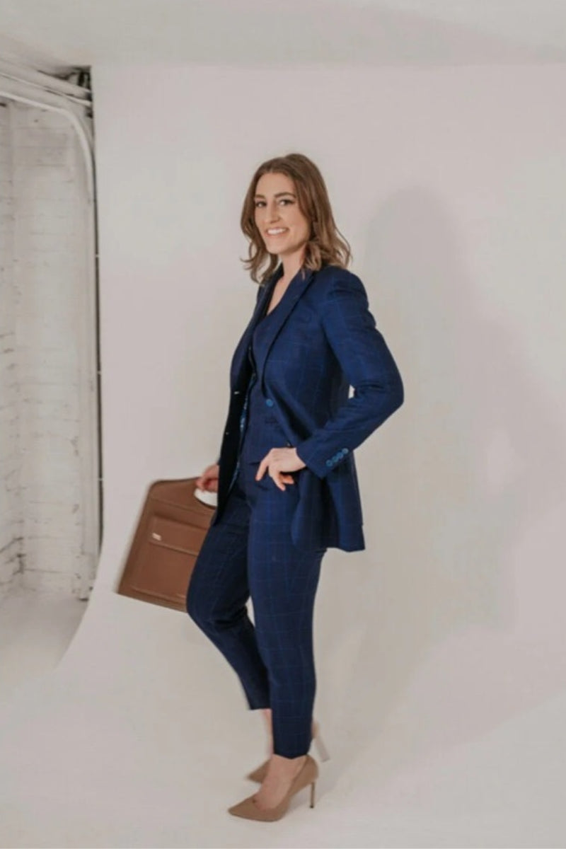 A woman wearing a three-piece navy suit set