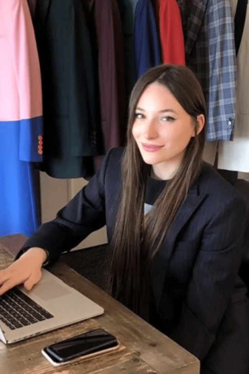 A professional in a tailored charcoal suit confidently embodying contemporary executive presence.