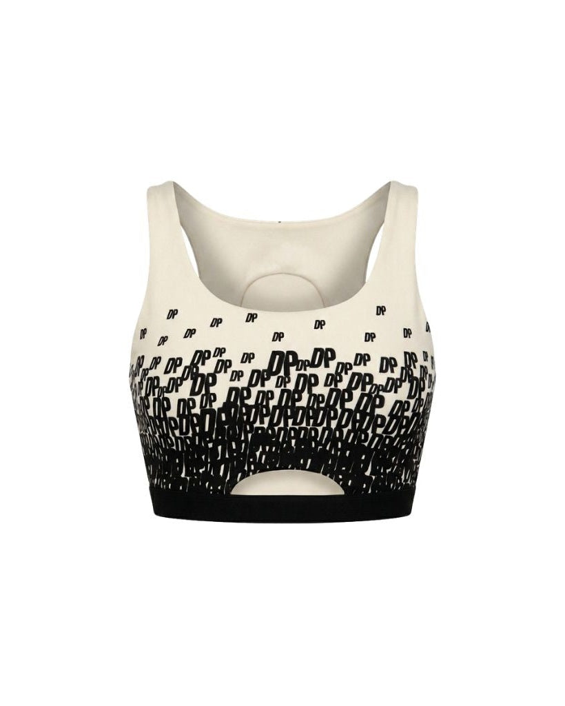 The Tailory New York X Dogpound Cropped Yoga Top in ivory featuring a sleeveless design with a bold black "DP" logo pattern fading upward and a supportive elastic band at the hem.
