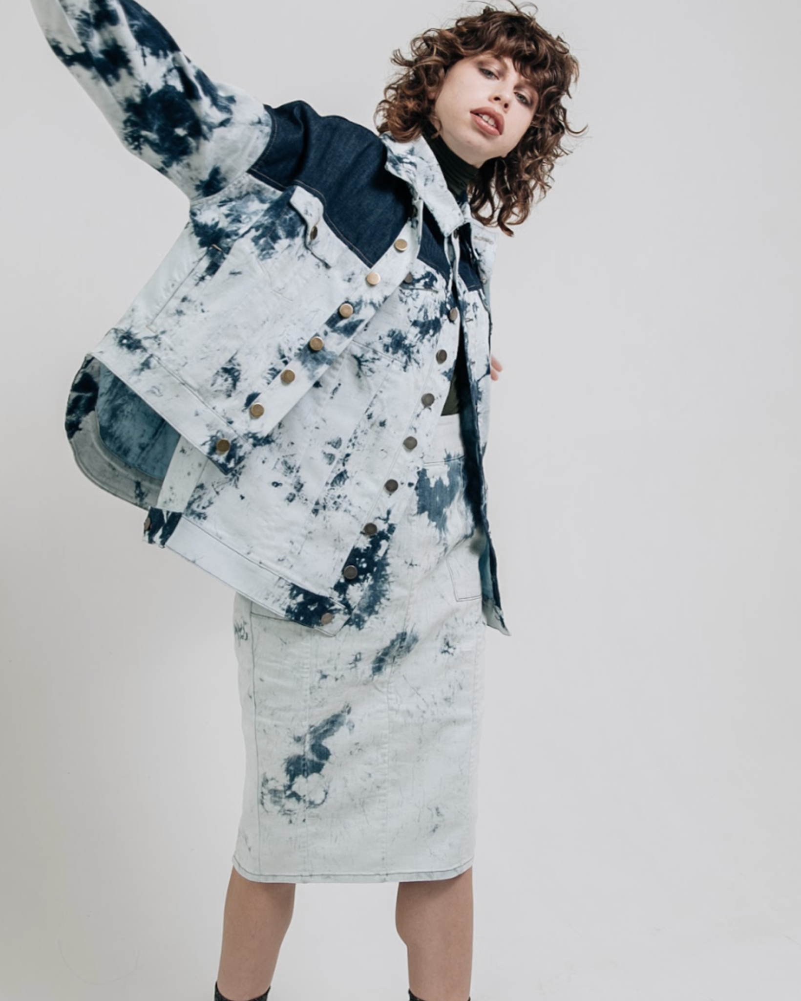 SAMPLE SALE | Tie Dye Denim Pencil Skirt featuring a high-waisted, slim fit silhouette in light indigo denim with unique dark blue tie-dye patterns for a bold, modern look.
