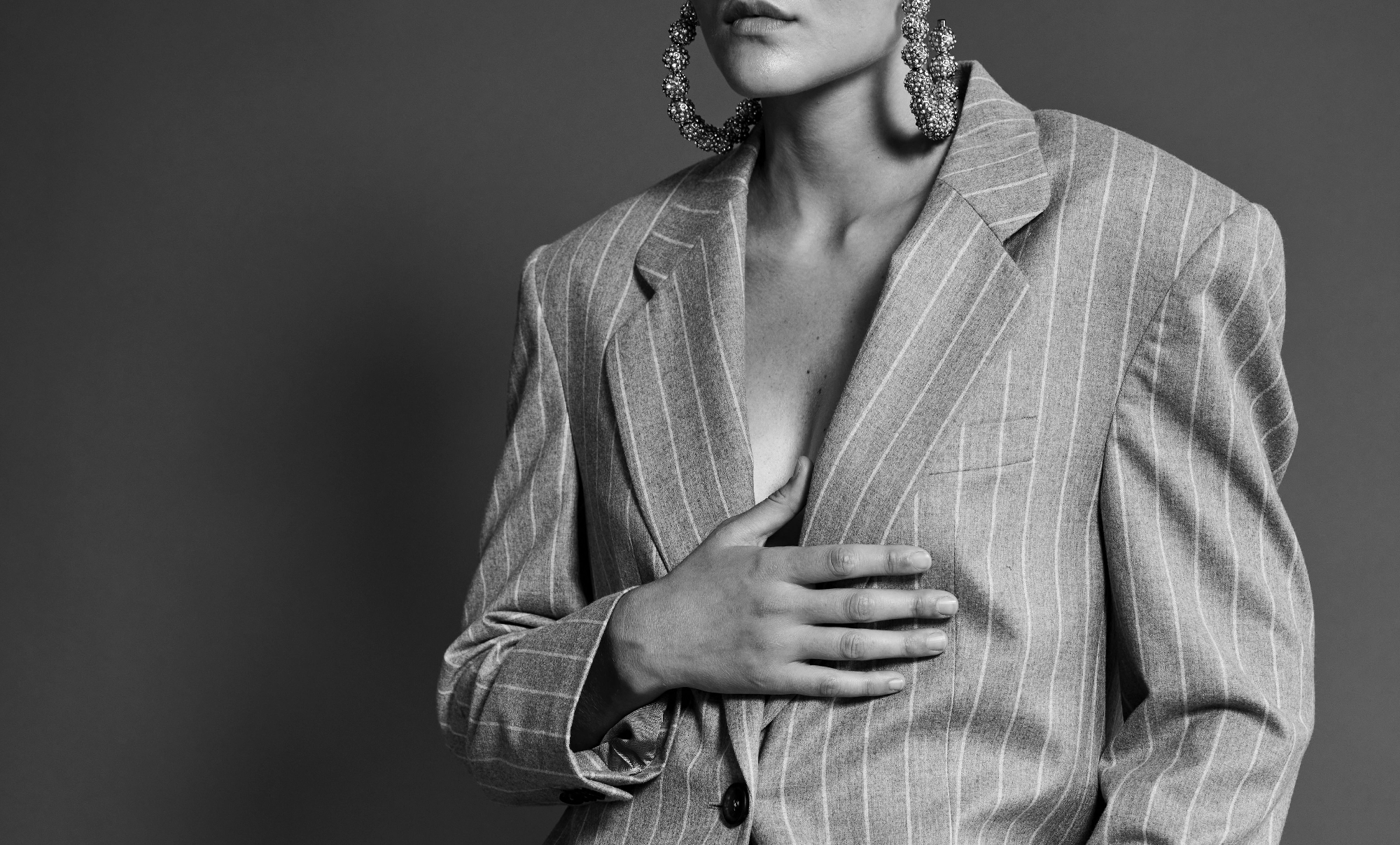 Person wearing a pinstripe suit with a plain background