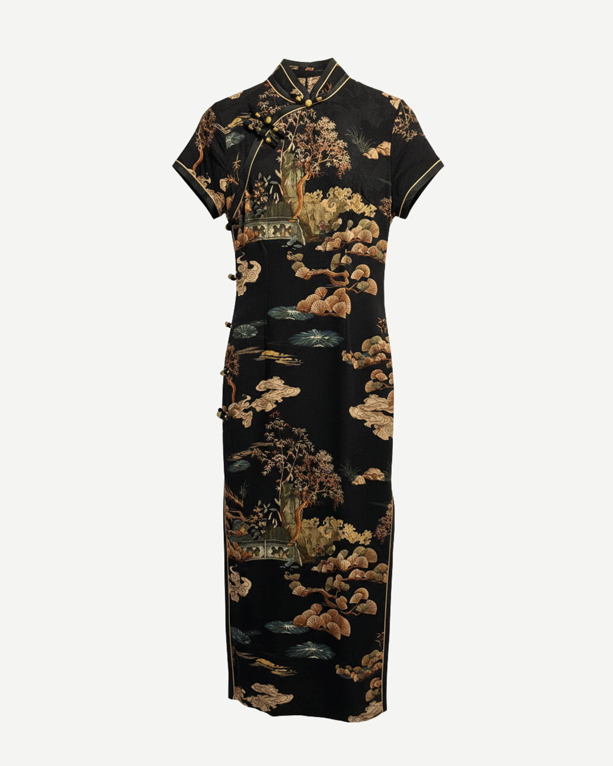 Traditional black dress with gold floral patterns on a white background