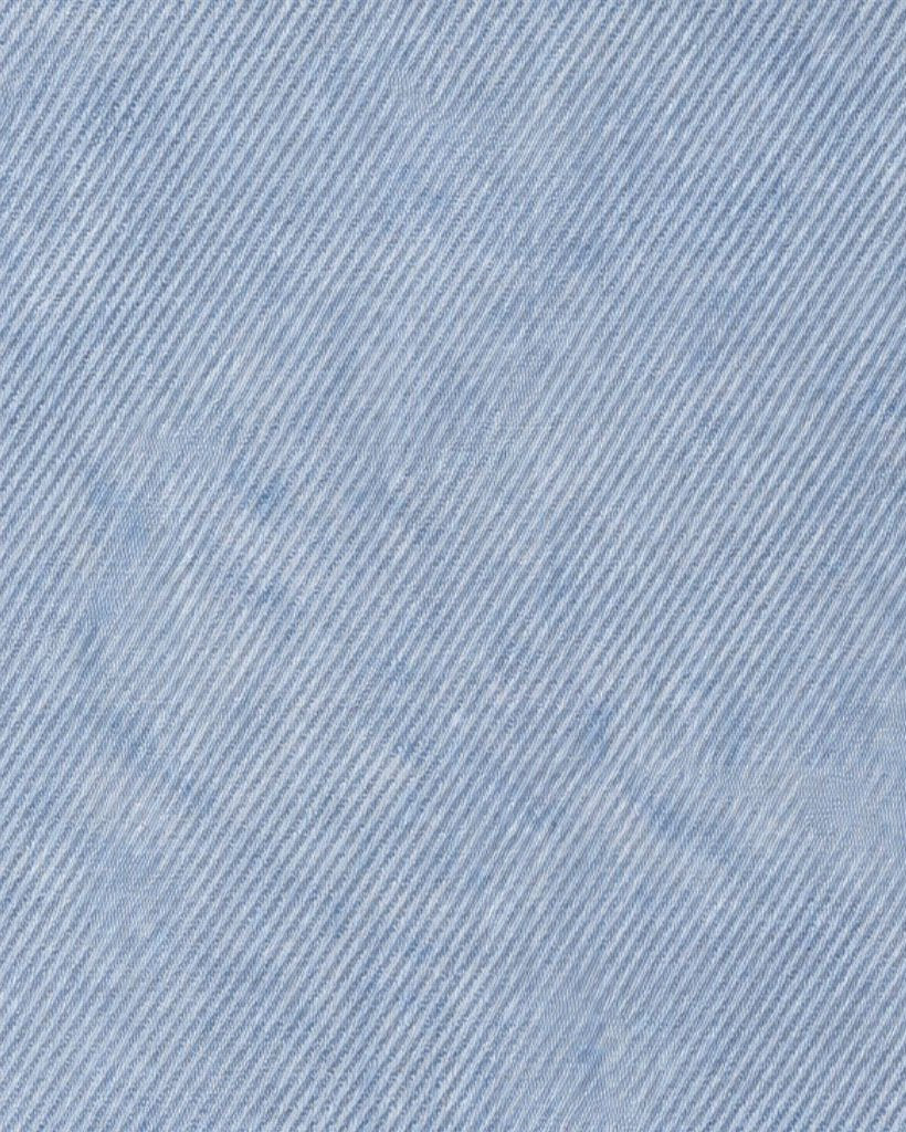 Close-up of the fabric texture in a Stonewashed Indigo Japanese Selvedge Denim Jacket, showcasing fine diagonal weave and subtle variations in indigo blue tones.
