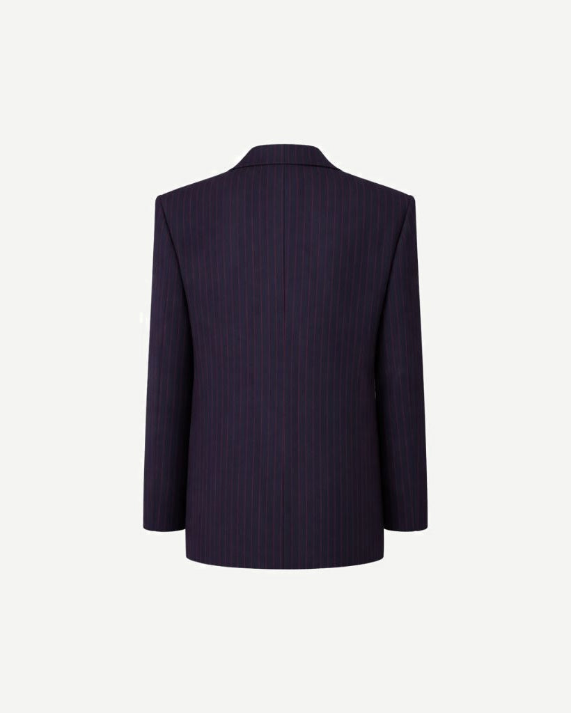Back view of the Navy Red Pinstripe Oversized Blazer, highlighting its relaxed fit, long sleeves, and vertical red pinstripes on a deep navy fabric for a bold yet sophisticated style.