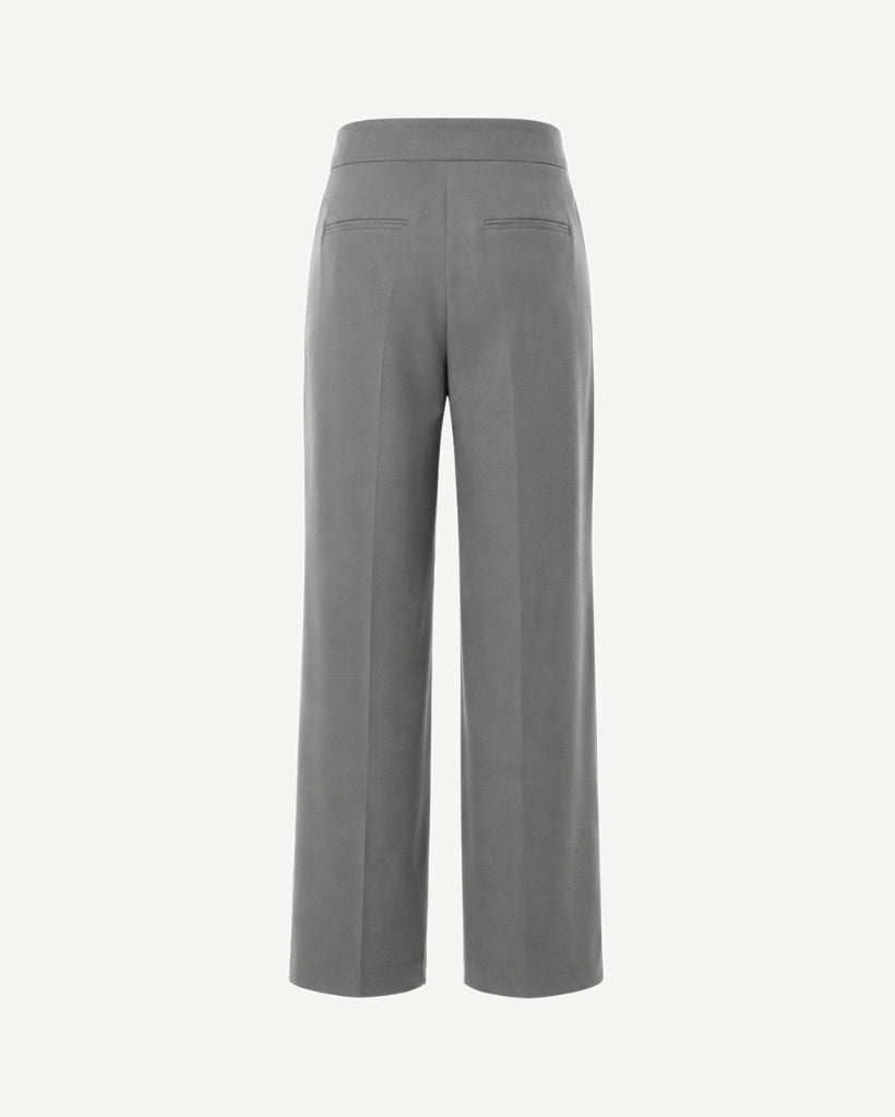 Back view of The Dailies Wide-Leg Trouser in grey suiting fabric with back welt pockets, clean waistband, pressed creases, and full-length wide-leg fit.