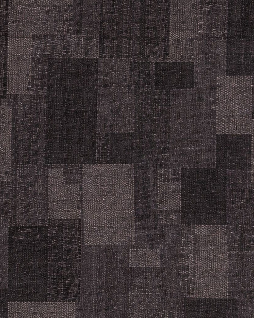 Close-up view of a textured jacquard fabric in varying shades of black and gray, highlighting the intricate pattern detail used in the Black Cropped Tuxedo Jacket with Jacquard Lapel.