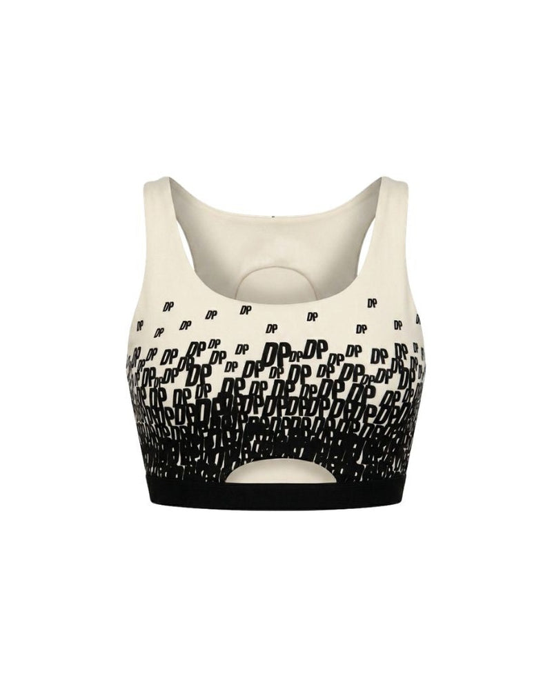 The Tailory New York X Dogpound Cropped Yoga Top in ivory featuring a sleeveless design with a bold black "DP" logo pattern fading upward and a supportive elastic band at the hem.