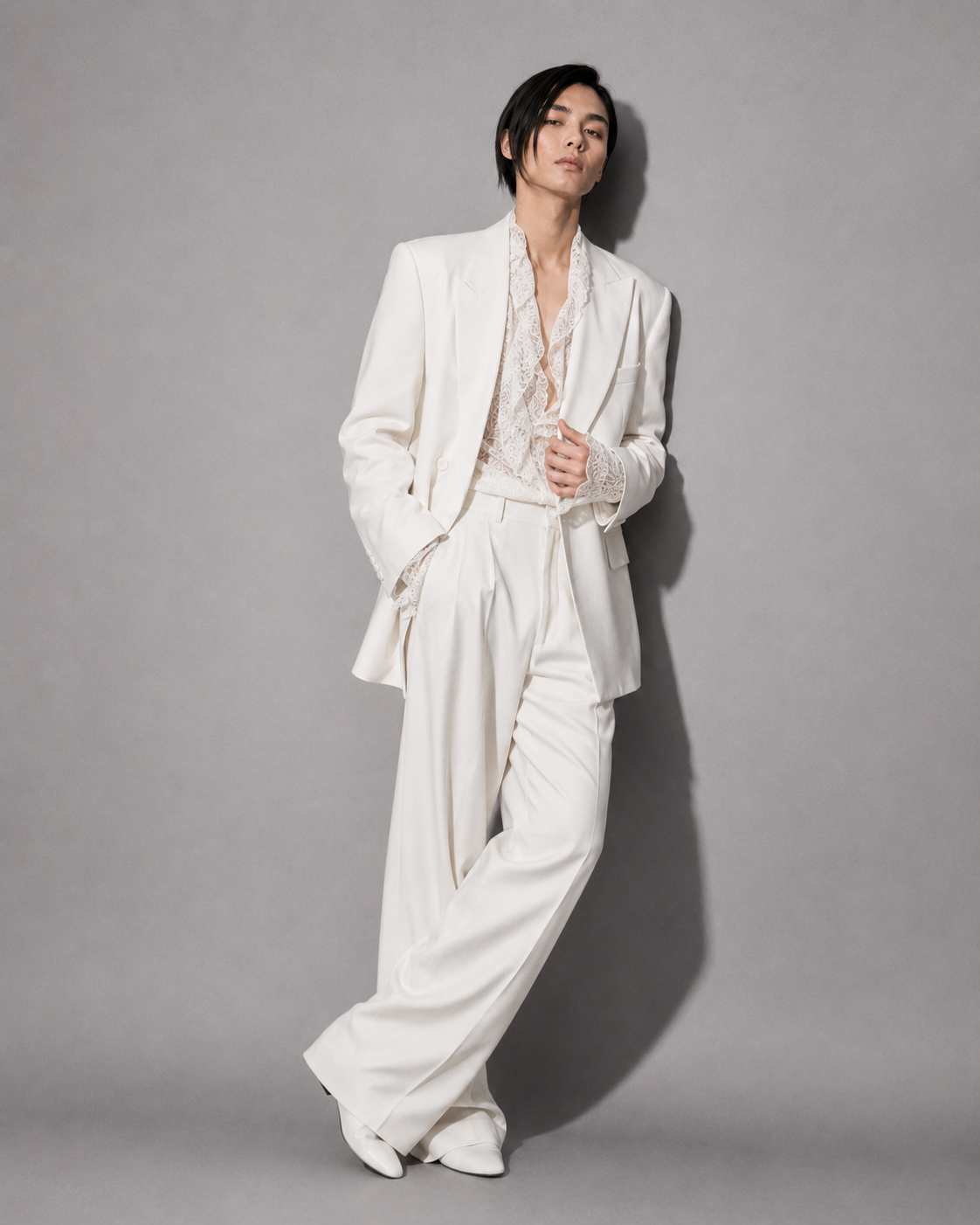 Person wearing a white suit with a plain background