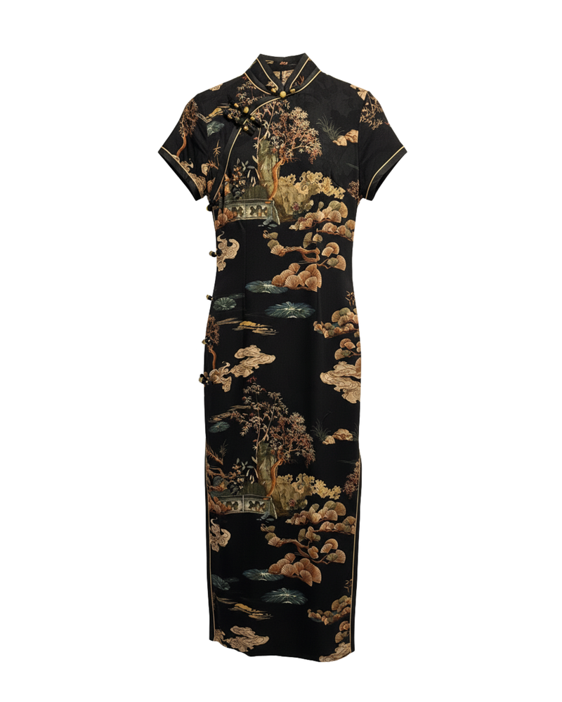 Traditional black dress with gold floral patterns on a white background