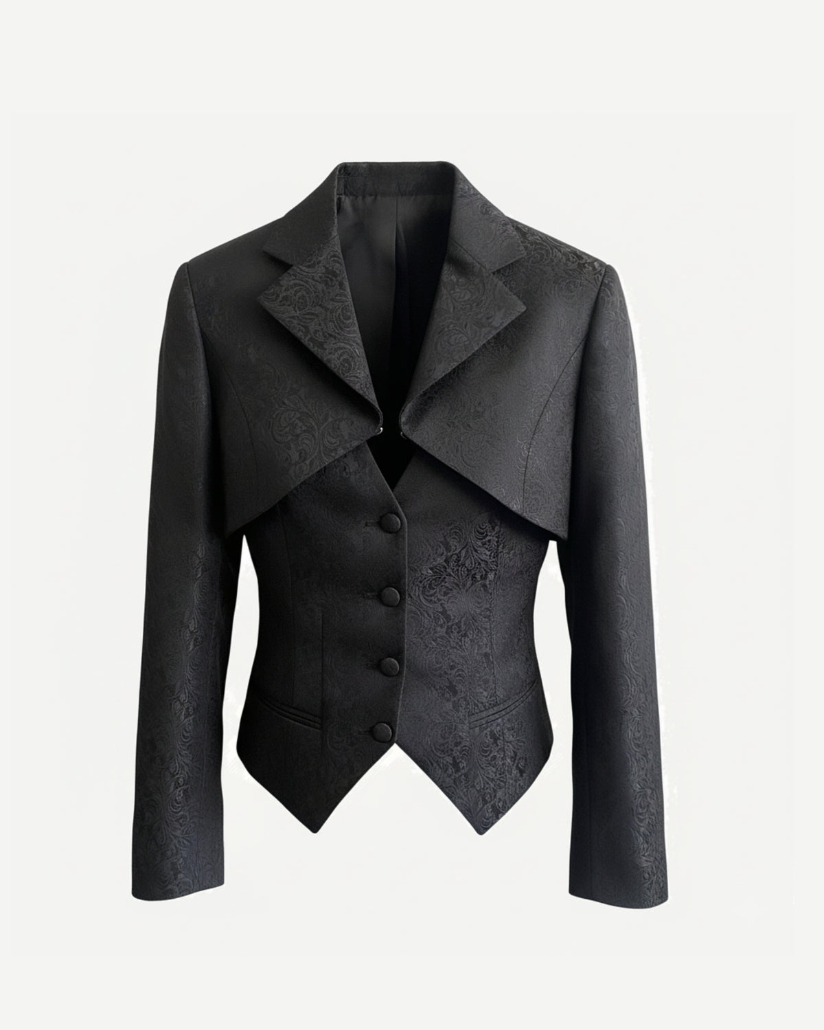Front view of black floral brocade cropped jacket with peak lapels and sculpted waist