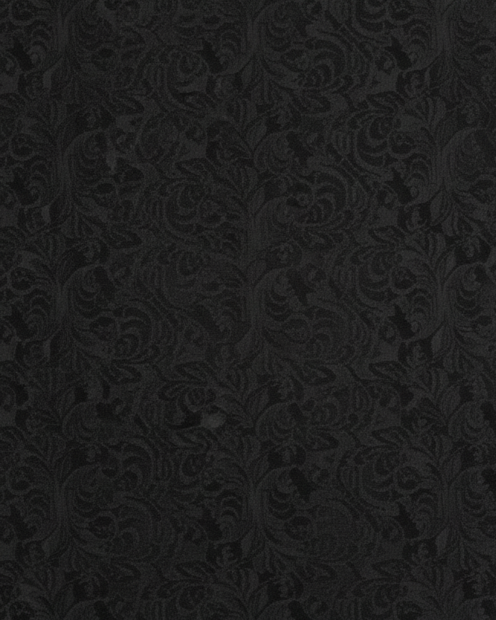 Close-up swatch of black floral brocade fabric used for the cropped jacket.