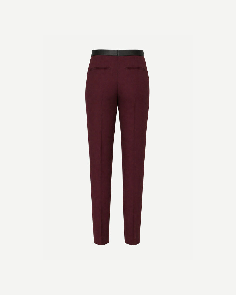 Burgundy Wool Satin-Waistband Tailored Trousers shown from the back, featuring a slim, tapered fit with welt pockets and a contrasting smooth satin waistband for refined, gender-neutral tailoring.