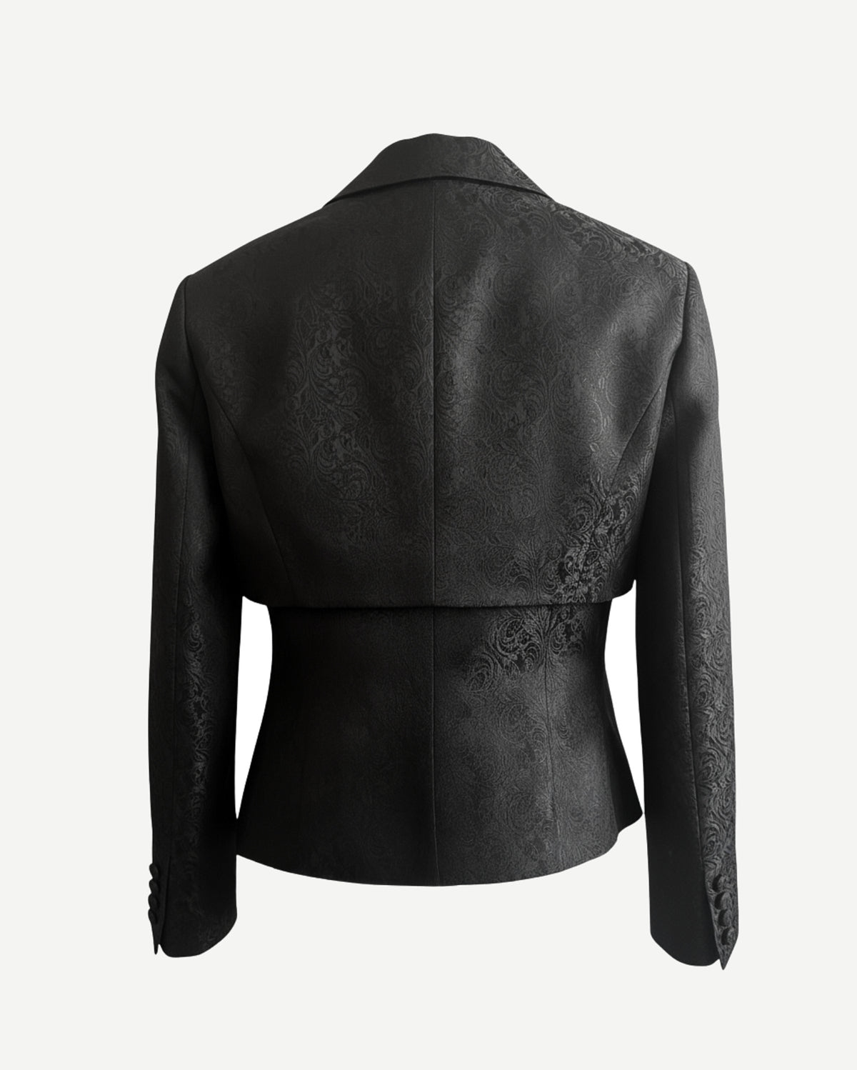 Black Cropped Blazer Cutout Formal Jacket shown from the back, featuring intricate floral brocade fabric, a tailored waist, long sleeves with buttoned cuffs, and a structured collar.