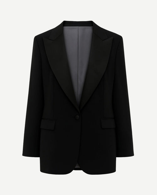 Black Oversized Tuxedo Jacket Exaggerated Peak Lapel Blazer featuring an oversized fit, bold peak lapels in satin, single-button closure, flap pockets, and smooth interior lining for striking formalwear.