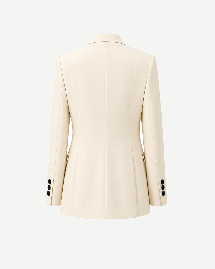 Ivory Peak Lapel Women’s Wool Tuxedo Jacket in a creamy ivory shade, showcasing a streamlined back with structured seams and black buttons on the cuff for refined formalwear.