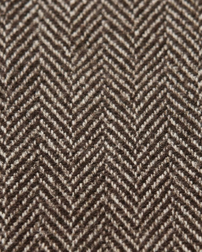 Close-up of the Loro Piana Brown Herringbone Wool Sportcoat fabric, showcasing its rich brown wool fibers woven in a classic herringbone pattern with fine texture and depth.