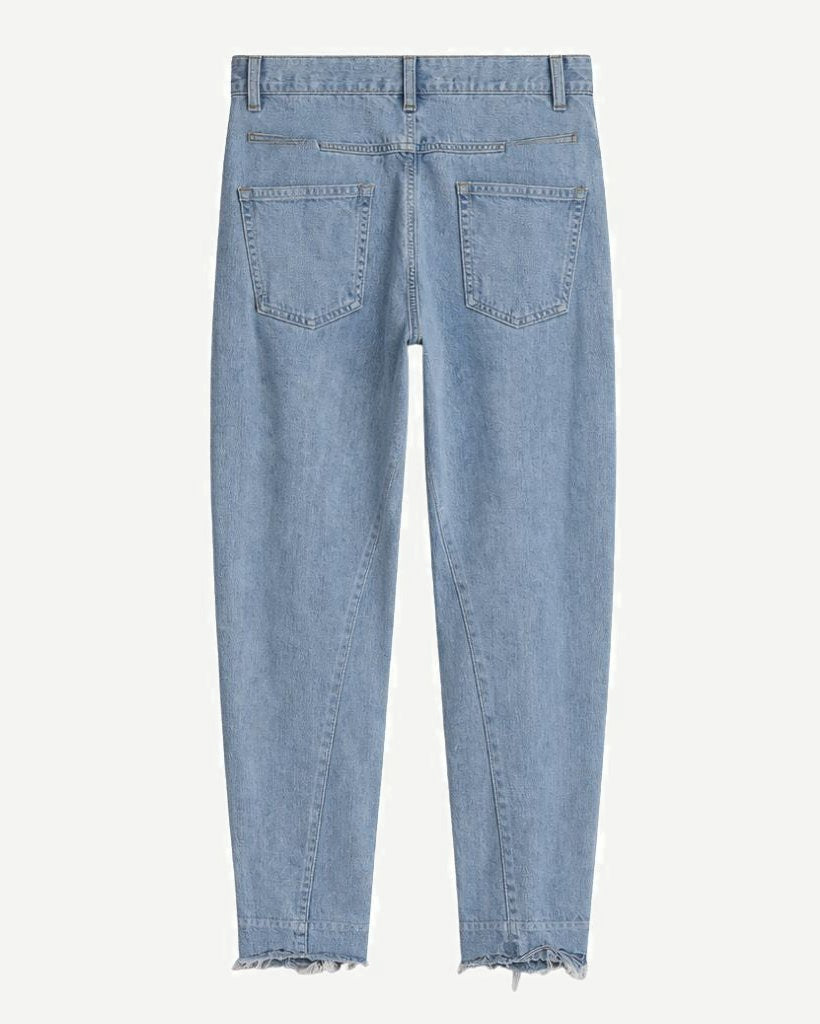 Loro Piana Light Wash Barrel Leg Wool Cashmere Blend Jeans in a soft light blue hue, featuring a relaxed fit with rear patch pockets and a subtly frayed hem for a refined casual look.