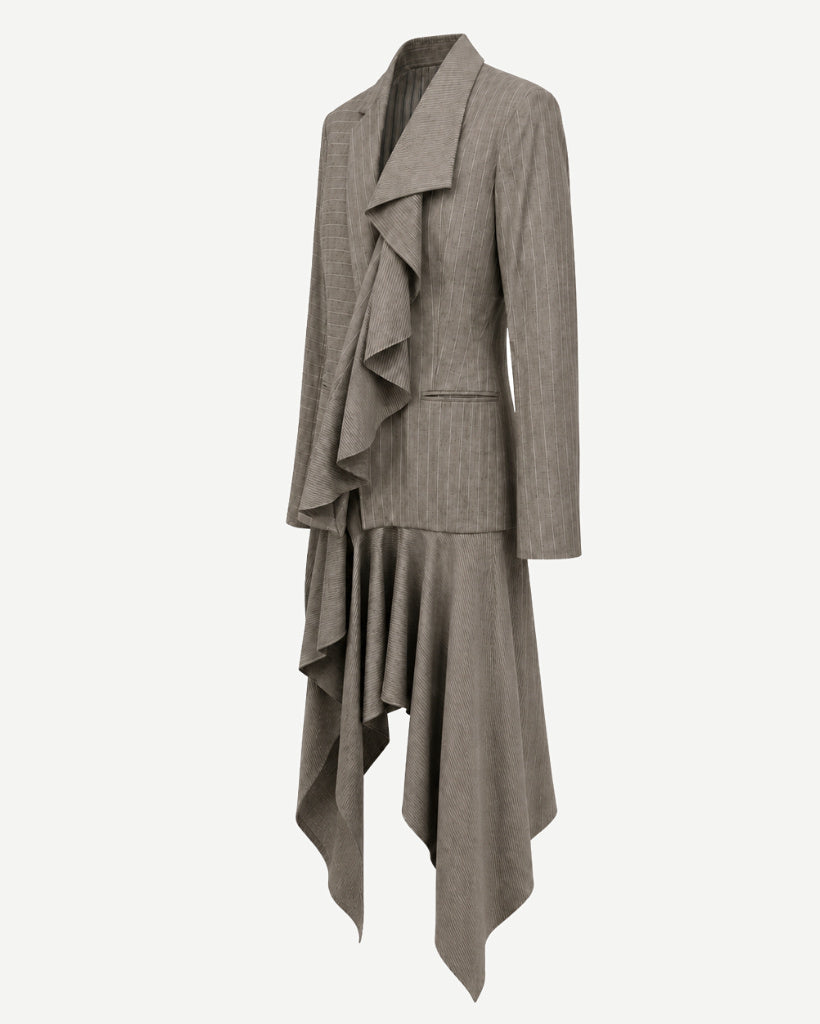 Right angled view of sculptural grey-taupe pinstripe tailored jacket showing the cascading front drape, structured blazer body, slim sleeve, and long asymmetric hem.