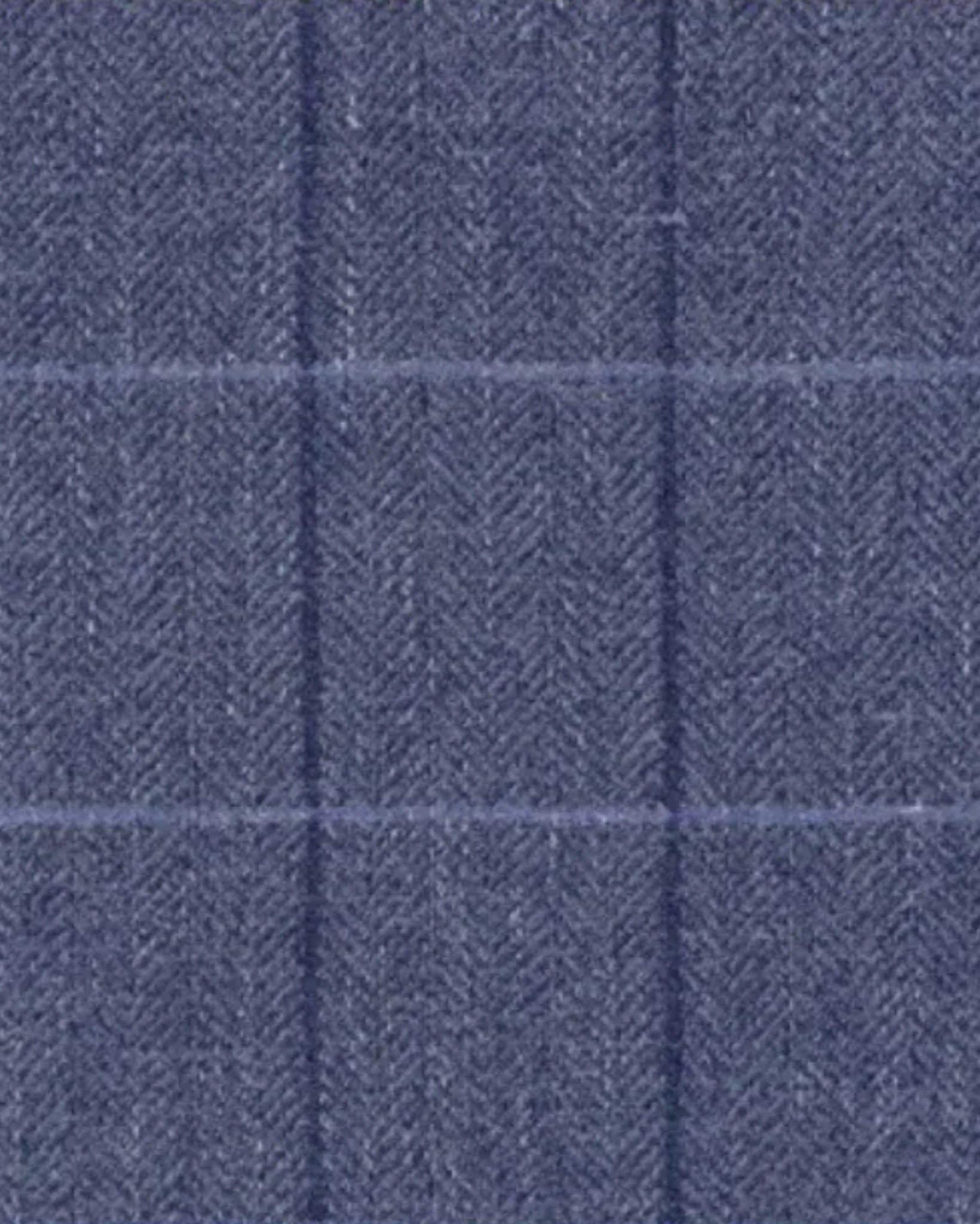 Close-up of blue herringbone wool fabric with a subtle windowpane pattern, highlighting the refined texture of the Blue Herringbone Overcoat | Raglan Sleeve Construction | Storm Shield.