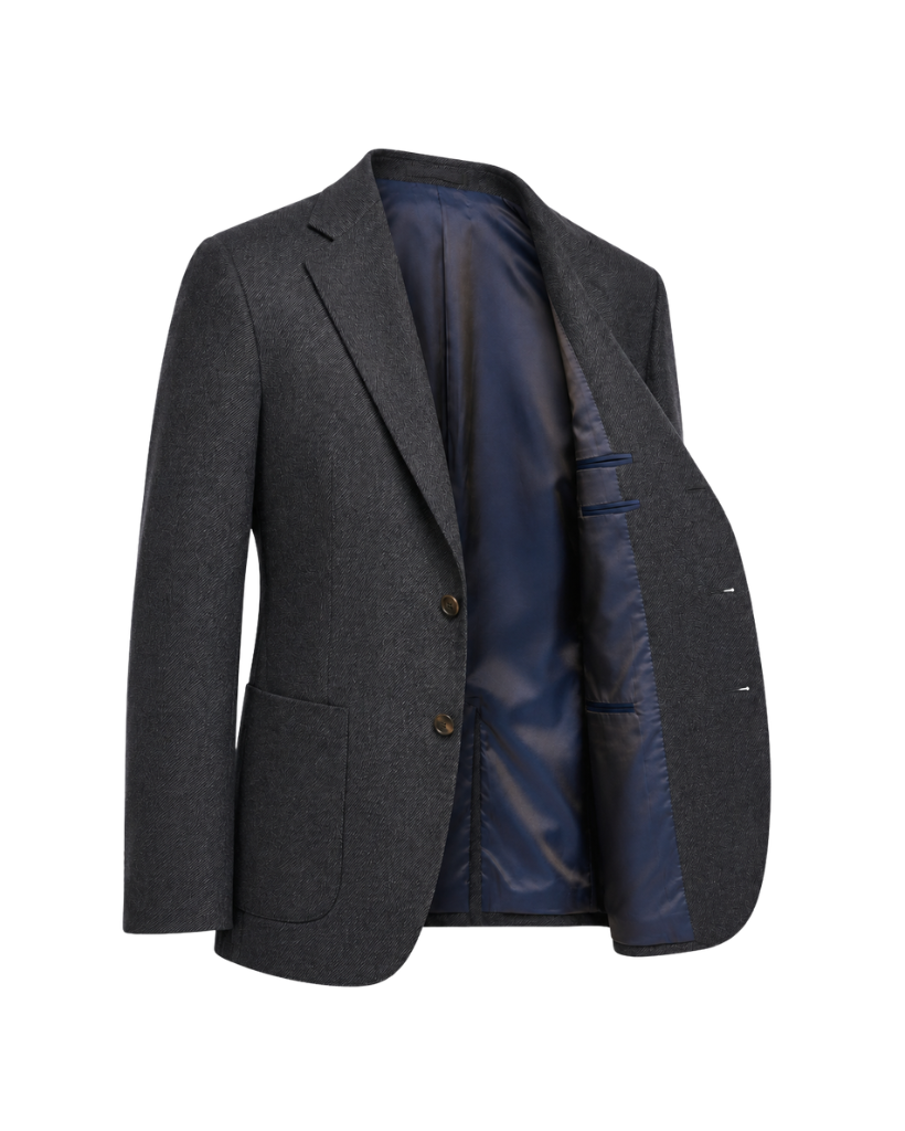 Open three-quarter view of The Wide-Frame Wool Sport Coat in dark charcoal wool, revealing the navy lining, interior pocketing, generous lapel, and relaxed tailored shape.