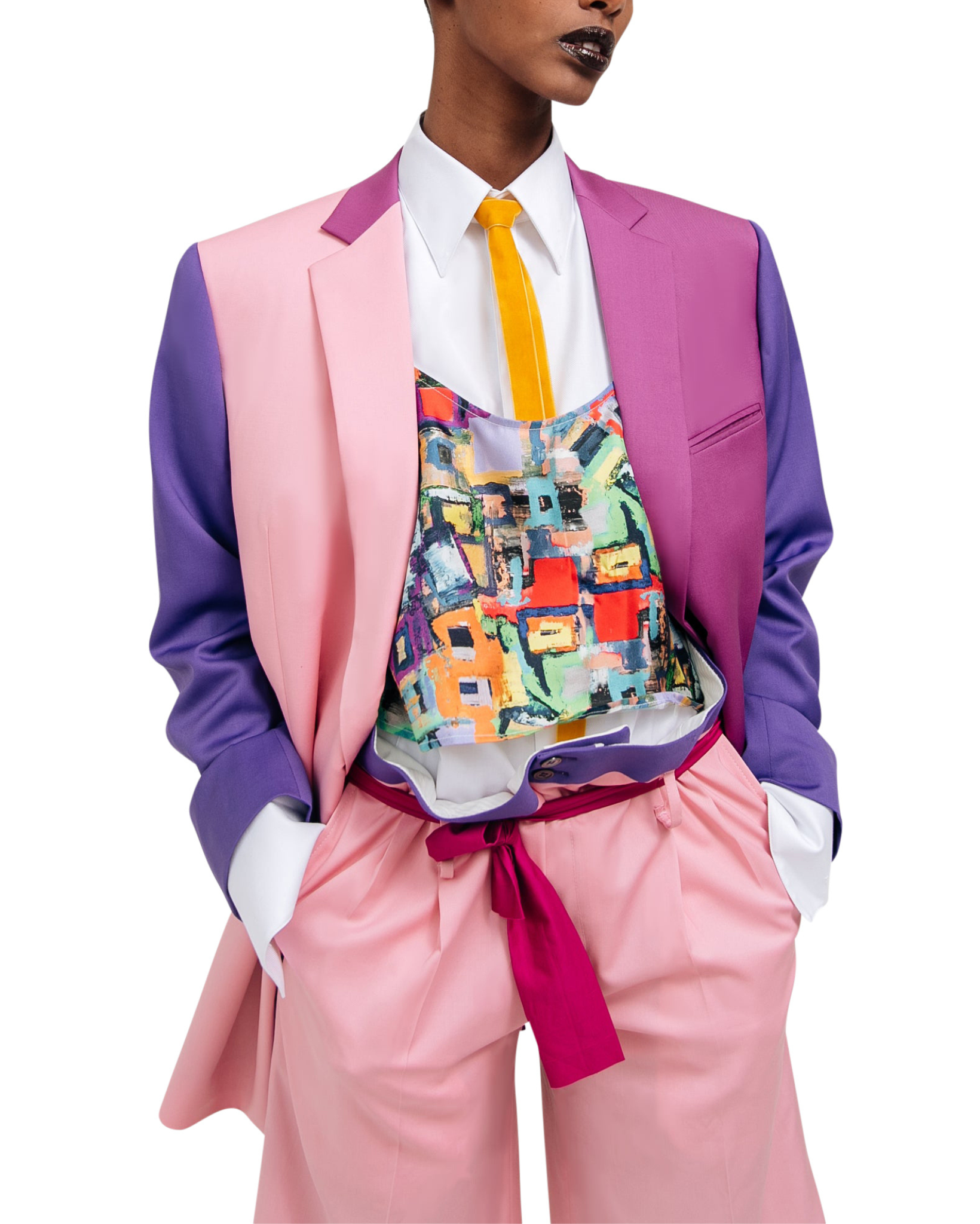 Model wearing the Pink Purple Color-Block Double-Breasted Blazer styled with a vibrant abstract print top and light pink high-waisted trousers, showcasing bold gender-neutral suiting.