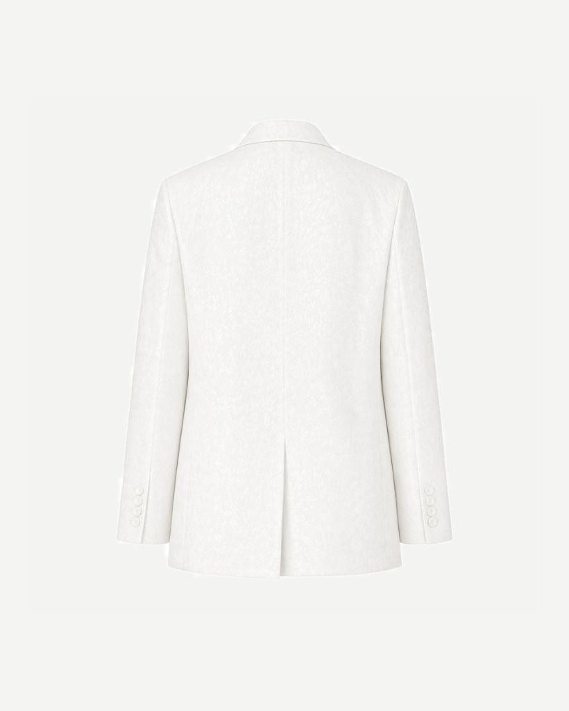 Back view of the White Jacquard Tuxedo Blazer featuring a subtle jacquard pattern in white fabric, tailored with a modern fit and rear vent for refined formal wear.